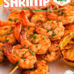 Tall graphic showcasing cajun shrimp recipe on skewers. Text overlay at top and bottom of image.