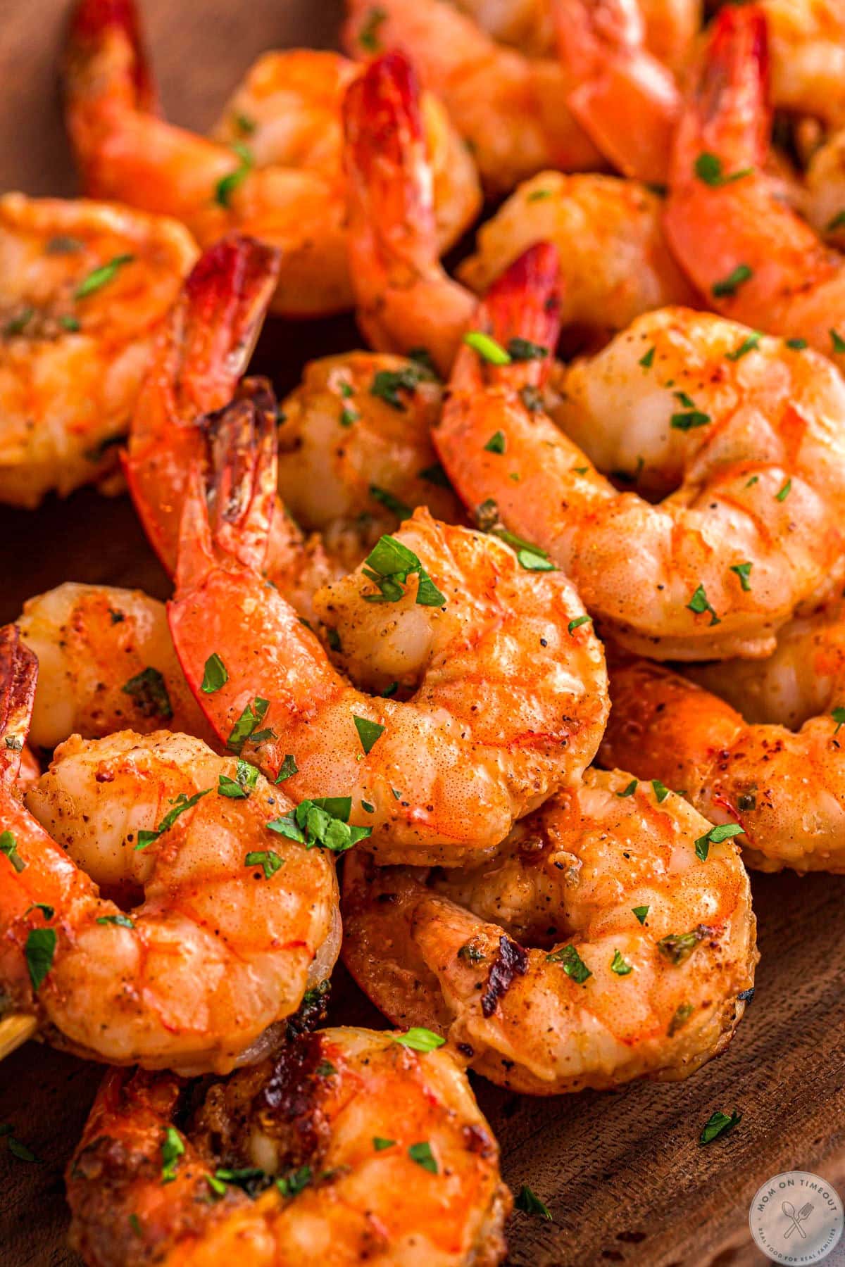 Cajun Shrimp grilled and served on skewers garnished with lemon and parsley.