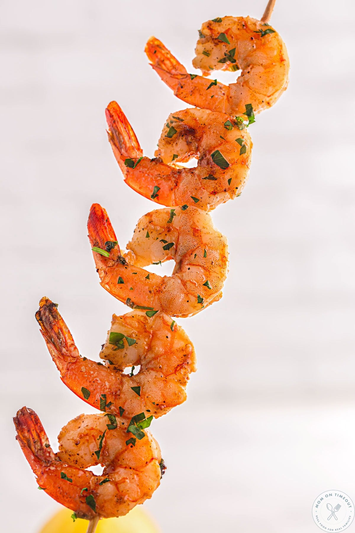 Single skewer with five cajun shrimp on it.