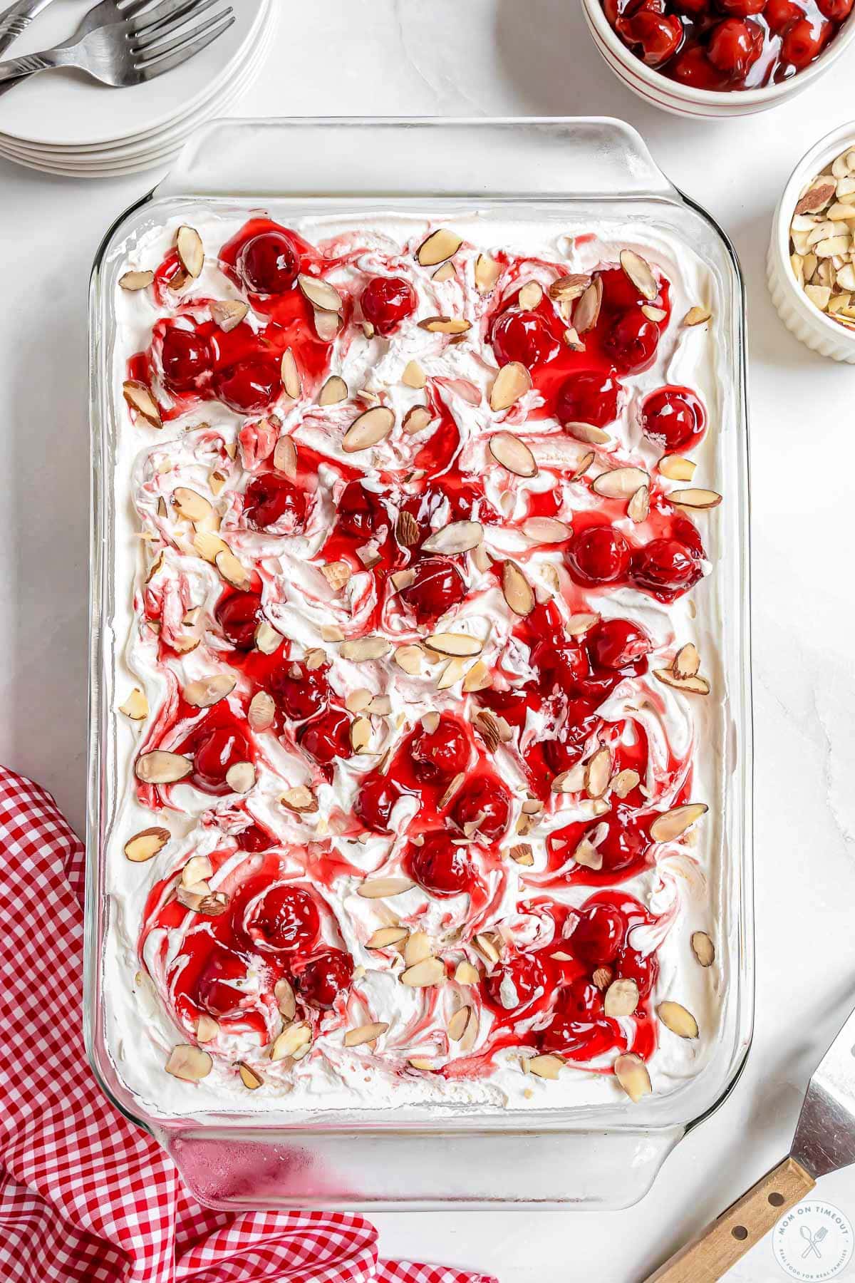Overhead shot of cherry heaven on earth cake in 9 x 13 glass baking dish. Topped with sliced almonds.
