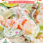 Large serving spoon with a scoop of cucumber shrimp salad being lifted away from the serving bowl. Text overlay at the top and bottom of image.