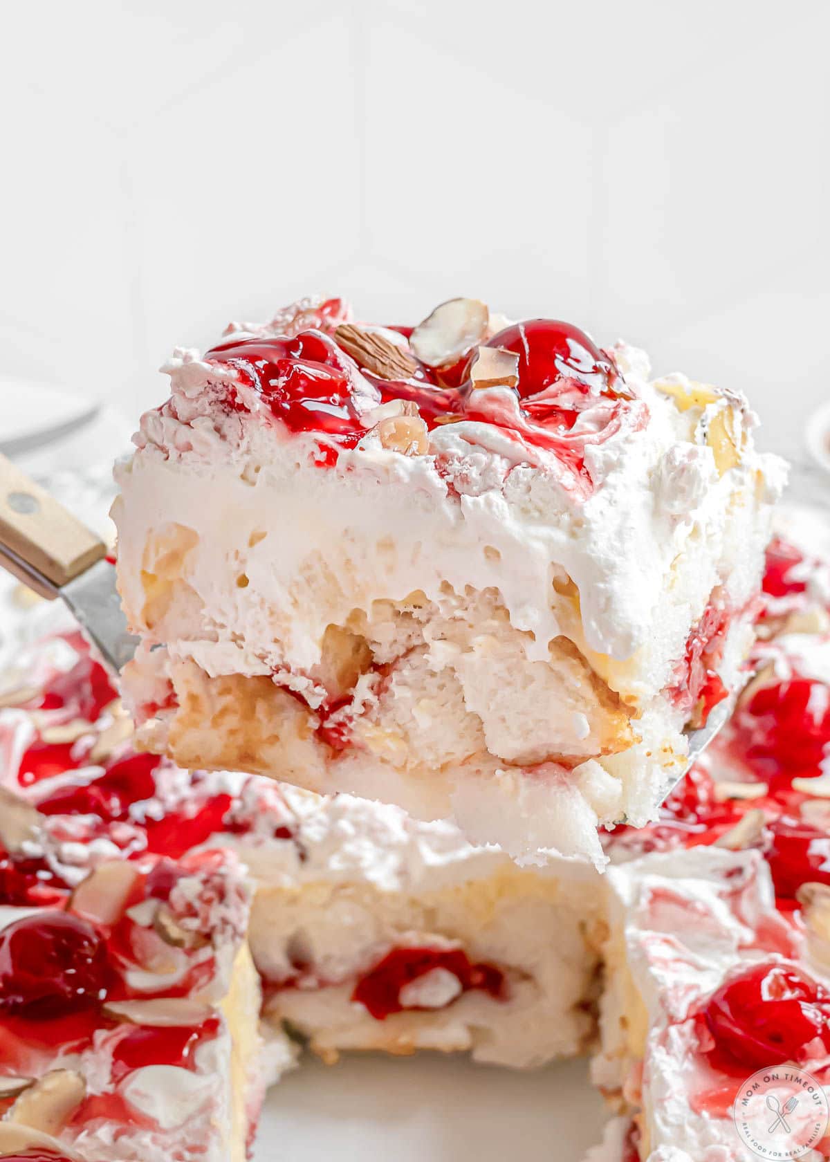 Serving of heaven on earth cake being lifted out of the baking dish.