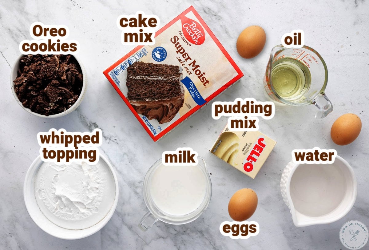 Overhead shot of oreo poke cake recipe ingredients. Ingredients are all labeled.