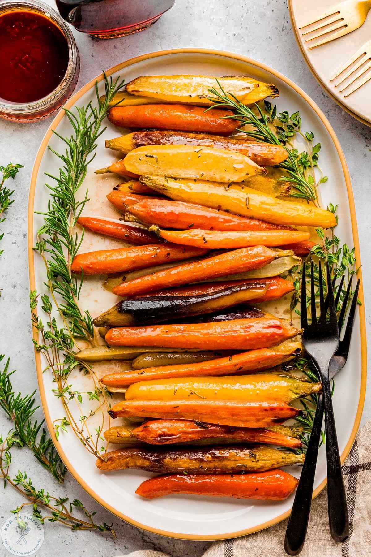 Overhead view of large oval platted with maple glazed carrots on it.