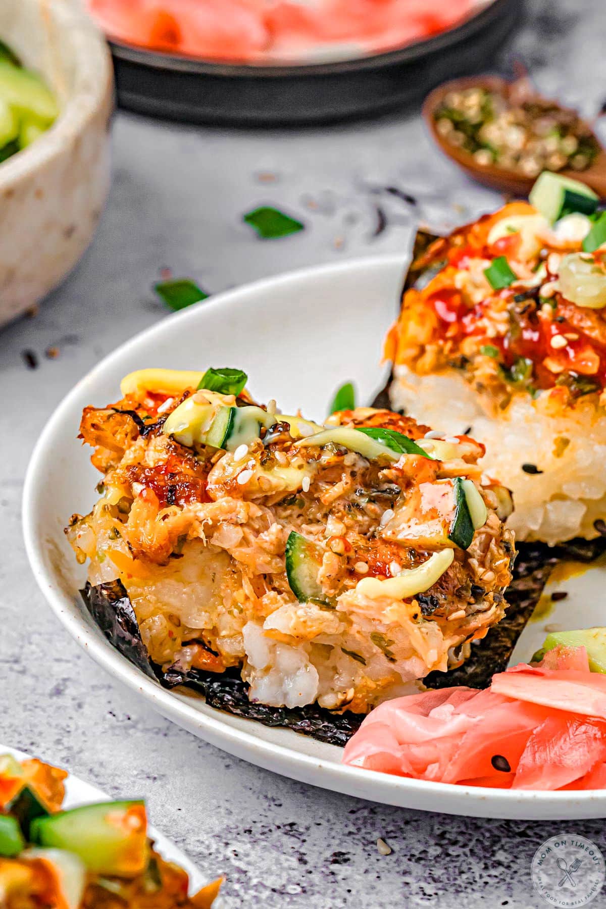 Sushi bake recipe served up on nori on white plates.