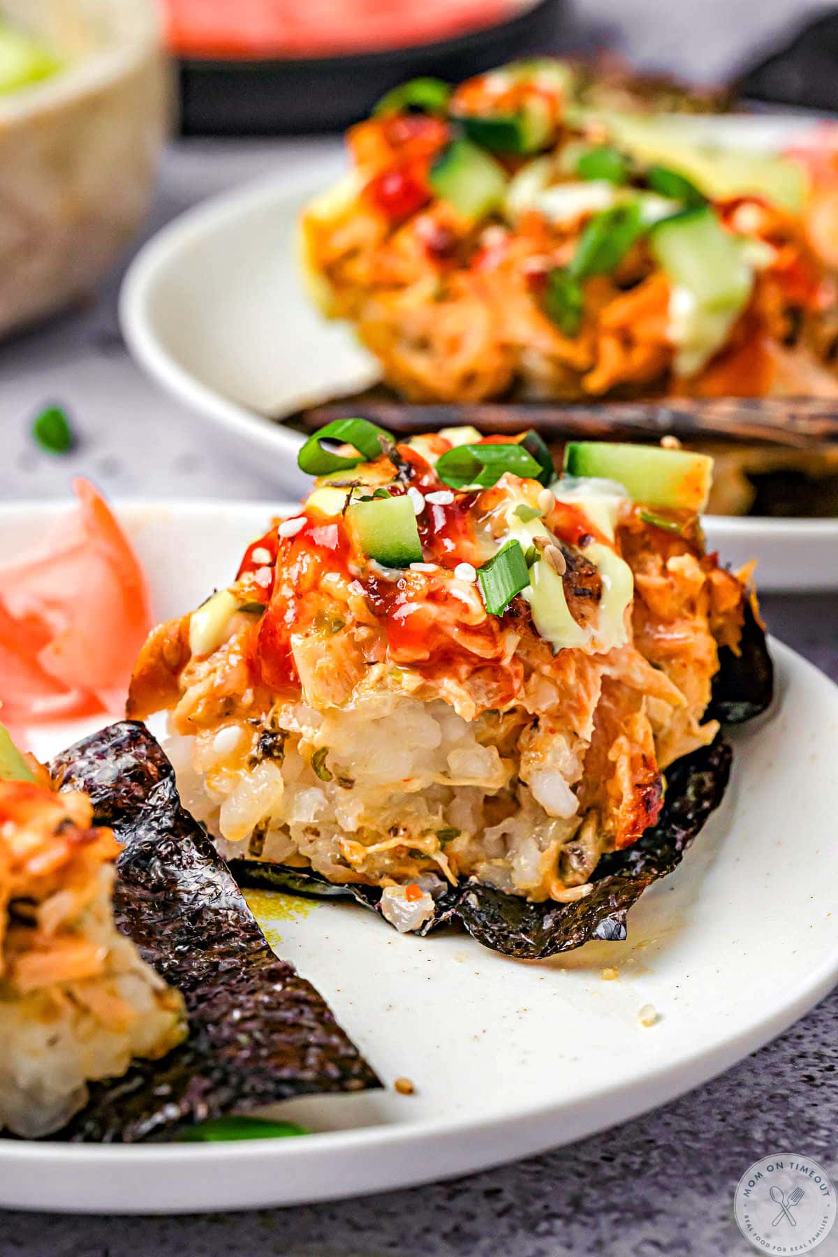 Sushi bake recipe served up on nori on white plates.
