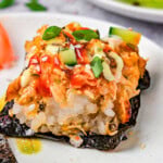 Sushi bake recipe served up on nori on white plates.