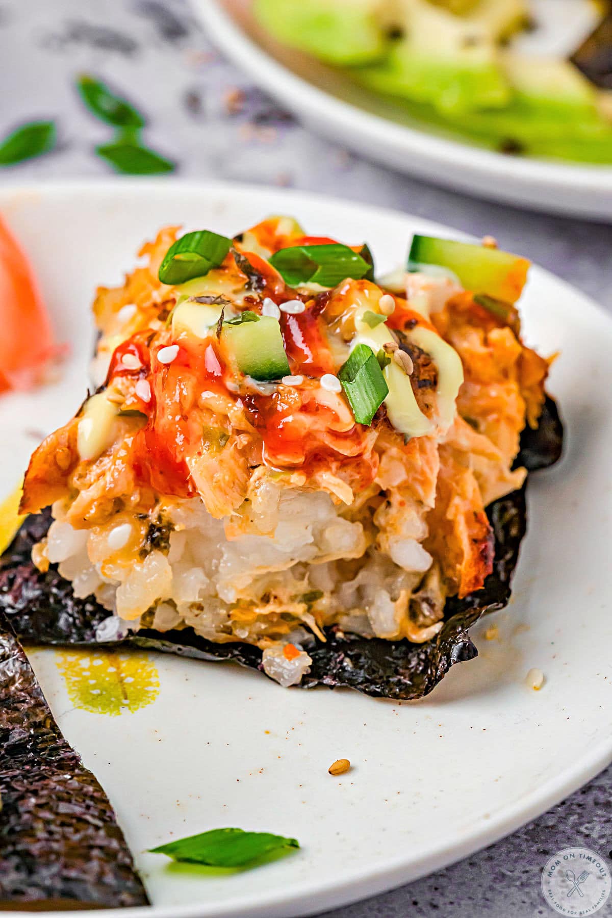 Sushi bake recipe served up on nori on white plates.